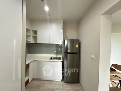 Modern compact kitchen with sleek design and stainless steel appliances.
