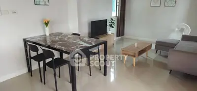 Modern living room with sleek dining table and cozy seating area