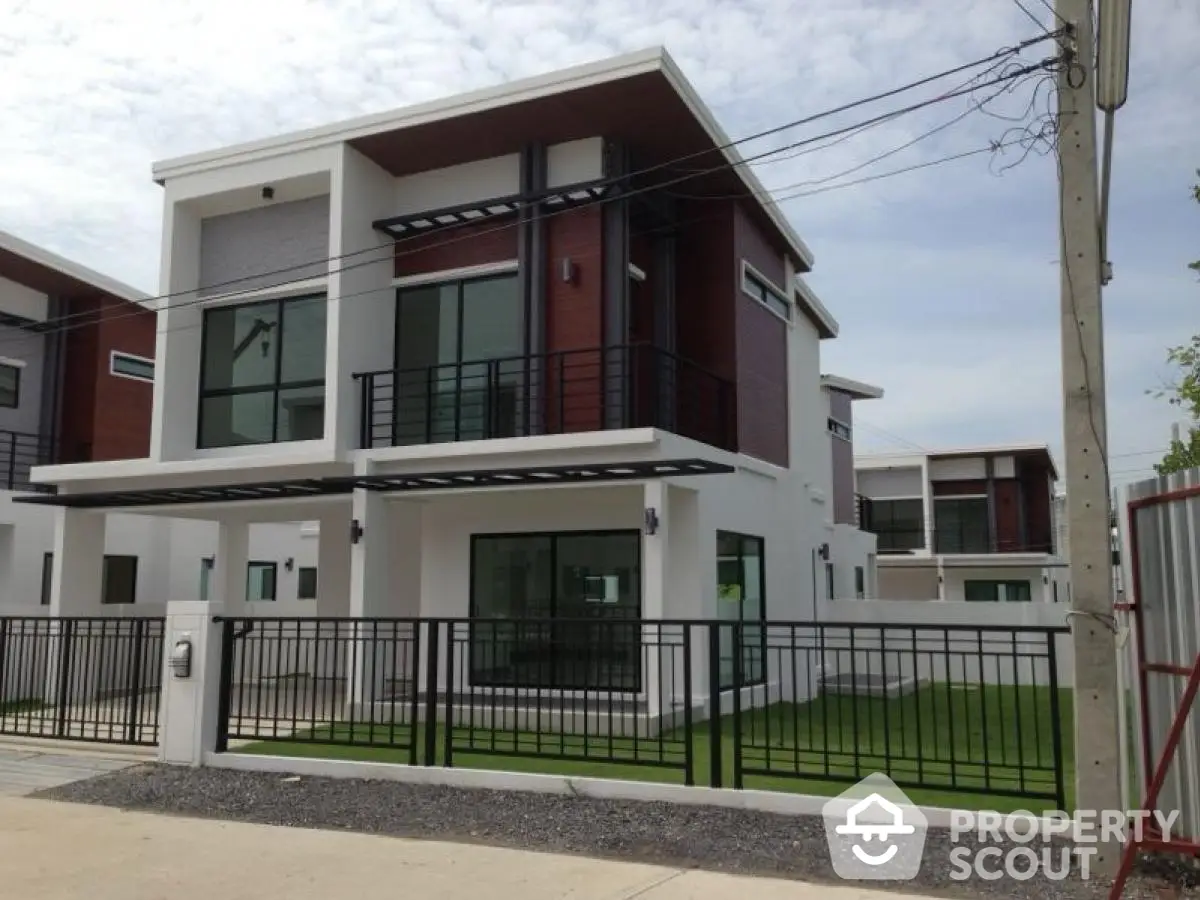 Modern two-story house with sleek design and spacious lawn