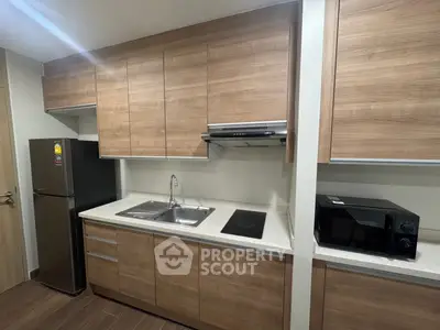 Modern kitchen with sleek wooden cabinets and appliances