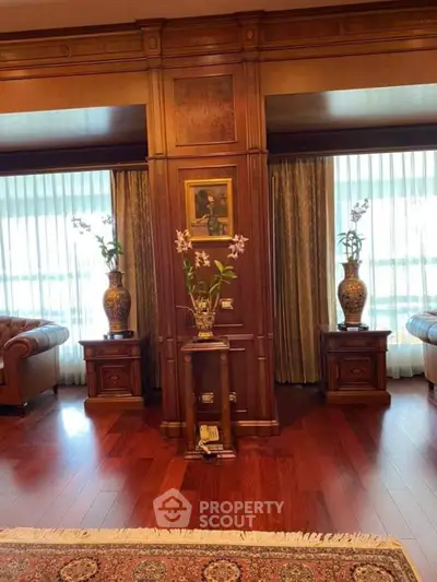 Luxurious living room with elegant wood paneling and plush leather sofas.