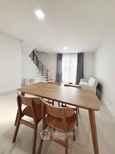 Spacious modern living room with dining area and natural light