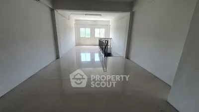Spacious empty room with glossy tiled floor and large window view