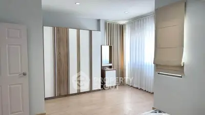 Spacious bedroom with modern wardrobe and natural light