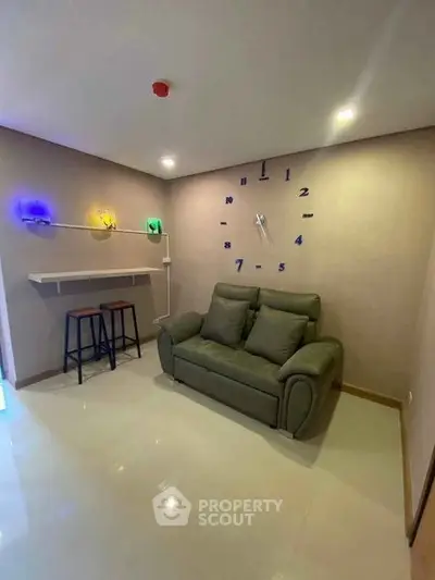 Modern living room with unique wall clock and cozy sofa