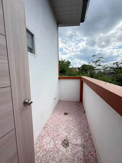 Charming small balcony with tiled floor and scenic view, perfect for relaxation.