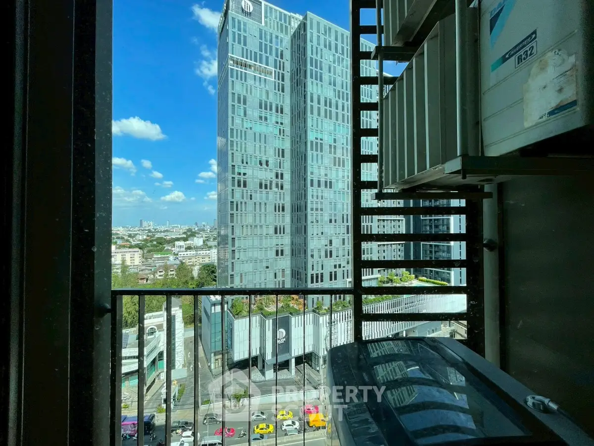 Stunning cityscape view from a high-rise balcony with modern architecture and vibrant urban life.