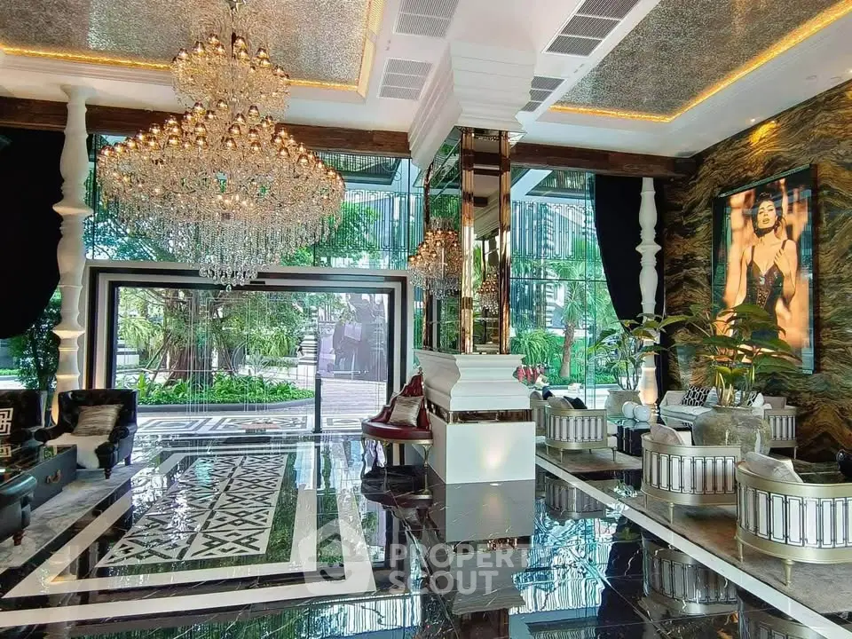 Luxurious living room with chandelier and floor-to-ceiling windows overlooking lush garden.