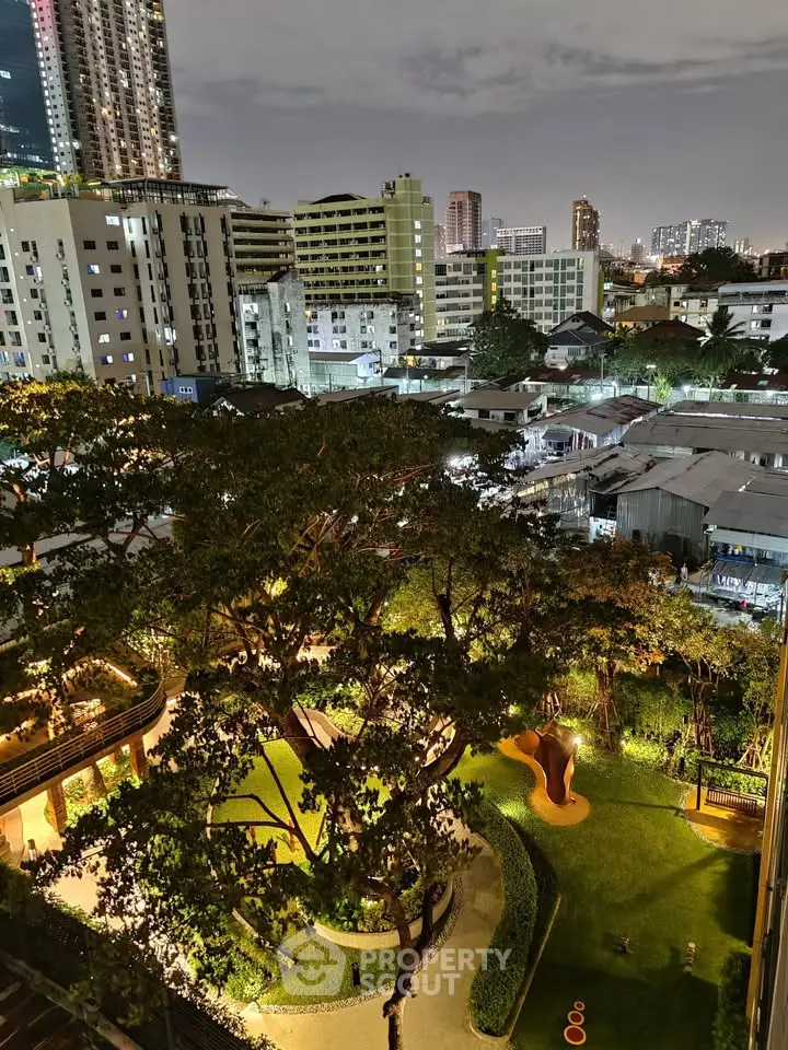 Stunning cityscape view from a high-rise apartment overlooking lush gardens and urban skyline at night.