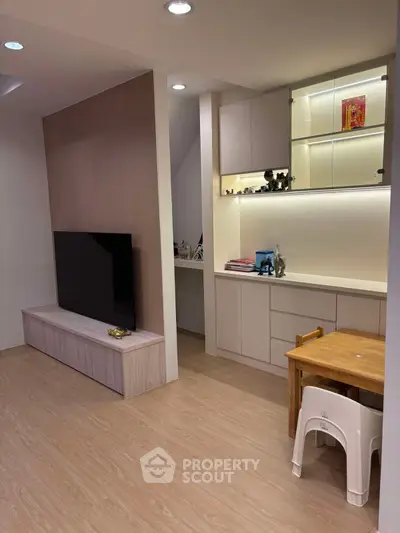 Modern living room with sleek TV setup and built-in storage