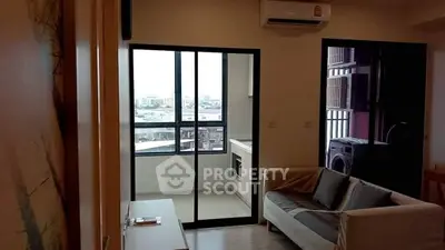 Modern living room with city view and compact kitchen in urban apartment