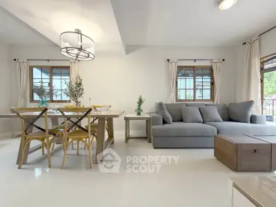 Spacious living room with modern furniture and natural light, perfect for family gatherings.