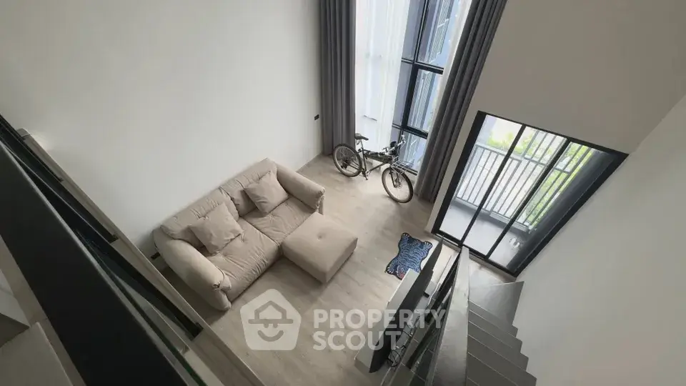 Modern loft apartment with high ceilings and balcony view