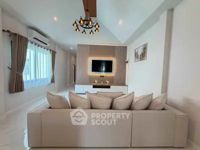 Spacious modern living room with elegant lighting and neutral decor