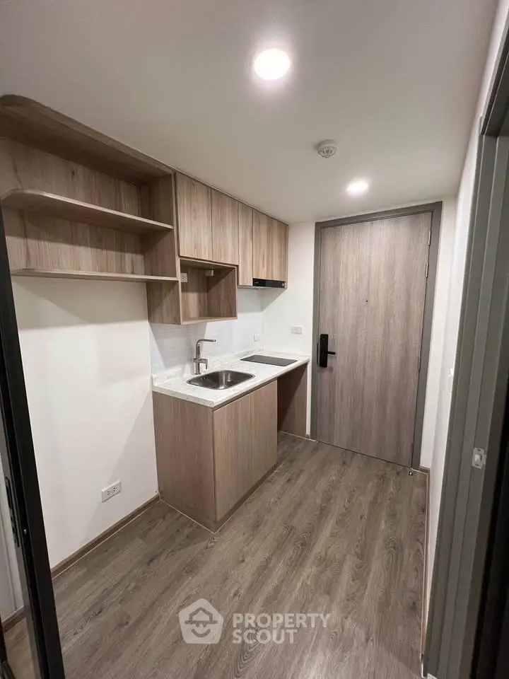 Modern compact kitchen with wooden cabinets and sleek design