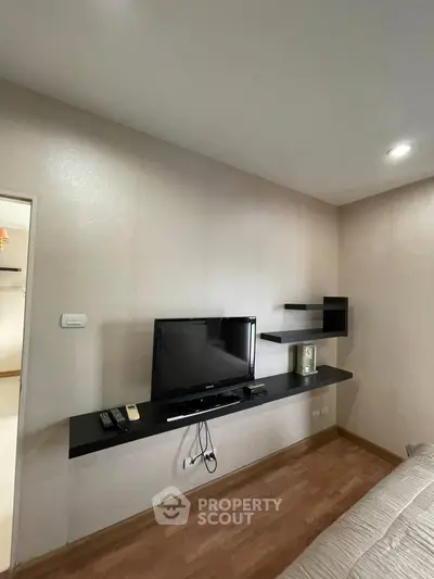 Modern living room with sleek TV setup and stylish shelving