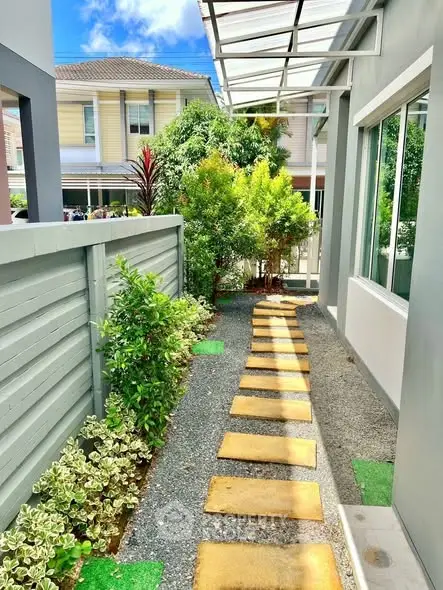 Charming garden path with lush greenery in modern residential area