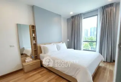 Bright and airy bedroom with large window and modern decor