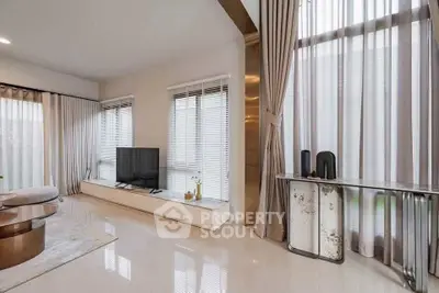 Luxurious living room with modern decor and large windows for natural light.