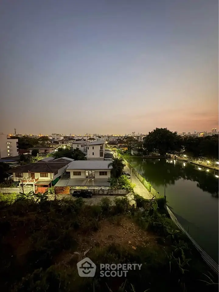 Stunning evening view of suburban homes by a serene lake, perfect for tranquil living.
