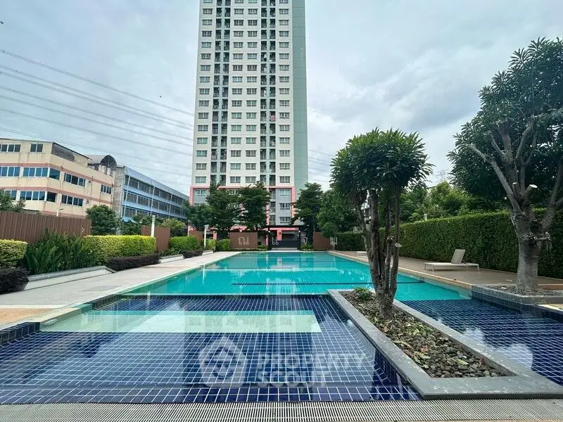 Luxurious condominium with stunning pool and lush greenery, perfect for modern living.