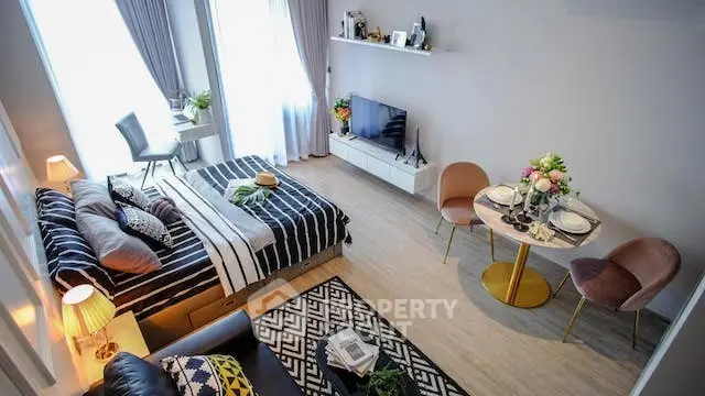 Stylish studio apartment with modern decor, cozy bed, and elegant dining area.