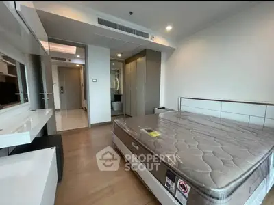 Modern bedroom with sleek design and ample natural light, featuring a comfortable bed and stylish decor.