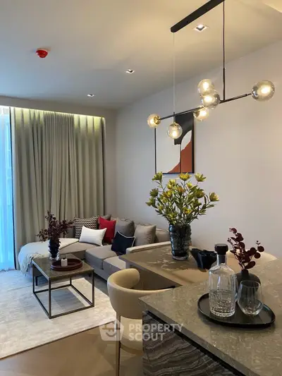 Modern living room with stylish decor and elegant lighting in a cozy apartment setting.