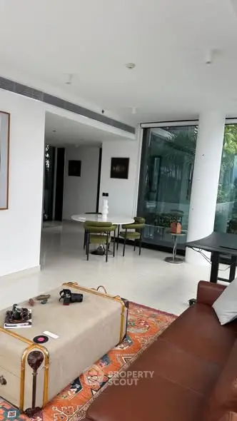 Luxurious modern living room with elegant decor and large windows offering natural light.