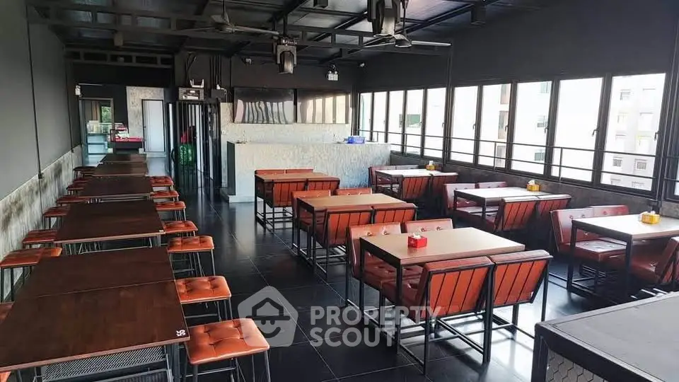 Spacious rooftop dining area with modern seating and panoramic city views.