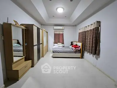 Spacious bedroom with modern furniture and ample natural light