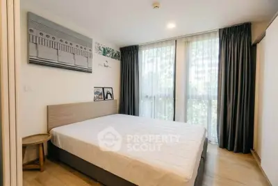 Bright and cozy bedroom with large windows and modern decor in a stylish apartment.