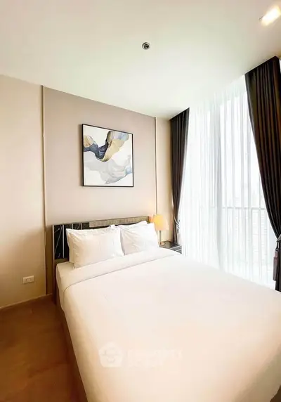 Modern bedroom with large window and stylish decor in a high-rise apartment.