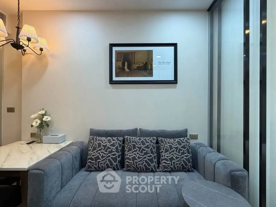 Modern living room with stylish gray sofa and elegant wall art, perfect for cozy relaxation.