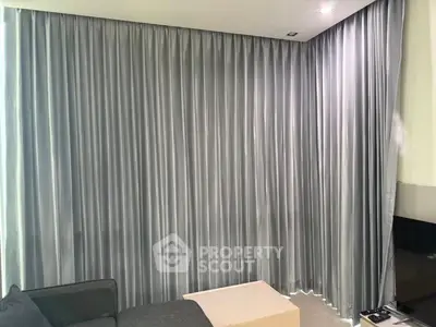 Modern living room with sleek gray curtains and minimalist furniture