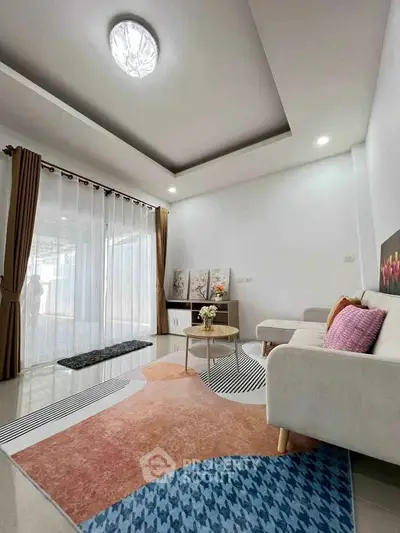 Modern living room with stylish decor and large windows for natural light.