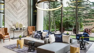 Luxurious modern living room with elegant decor and large windows overlooking a lush garden.