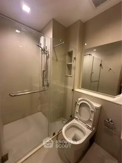 Modern bathroom with glass shower and sleek toilet design