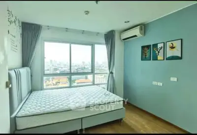 Spacious bedroom with city view, modern decor, and large windows in a high-rise apartment.