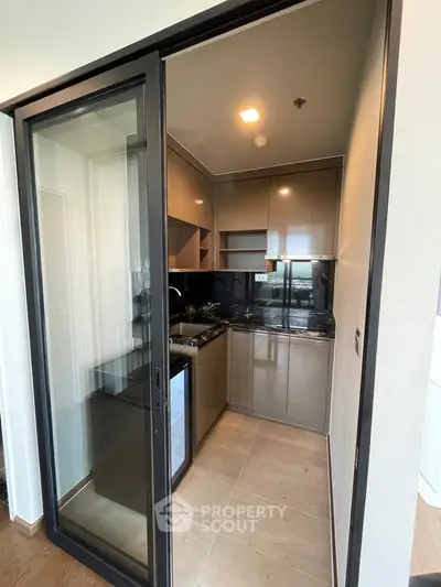 Modern closed kitchen with sleek cabinets and gas stove in compact layout