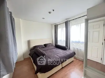 Cozy bedroom with large bed, natural light, and modern decor