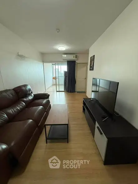 Spacious living room with leather sofa and modern TV unit