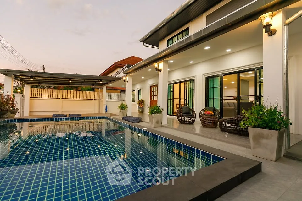 Luxurious modern home with stunning poolside view at sunset