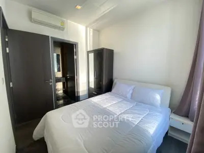 Cozy bedroom with modern furnishings and ample natural light