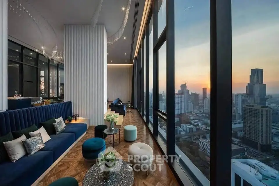 Luxurious high-rise living room with panoramic city views and elegant decor at sunset.