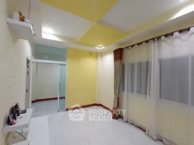 Spacious living room with modern ceiling design and large windows