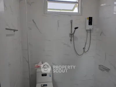 Modern bathroom with marble tiles and shower heater