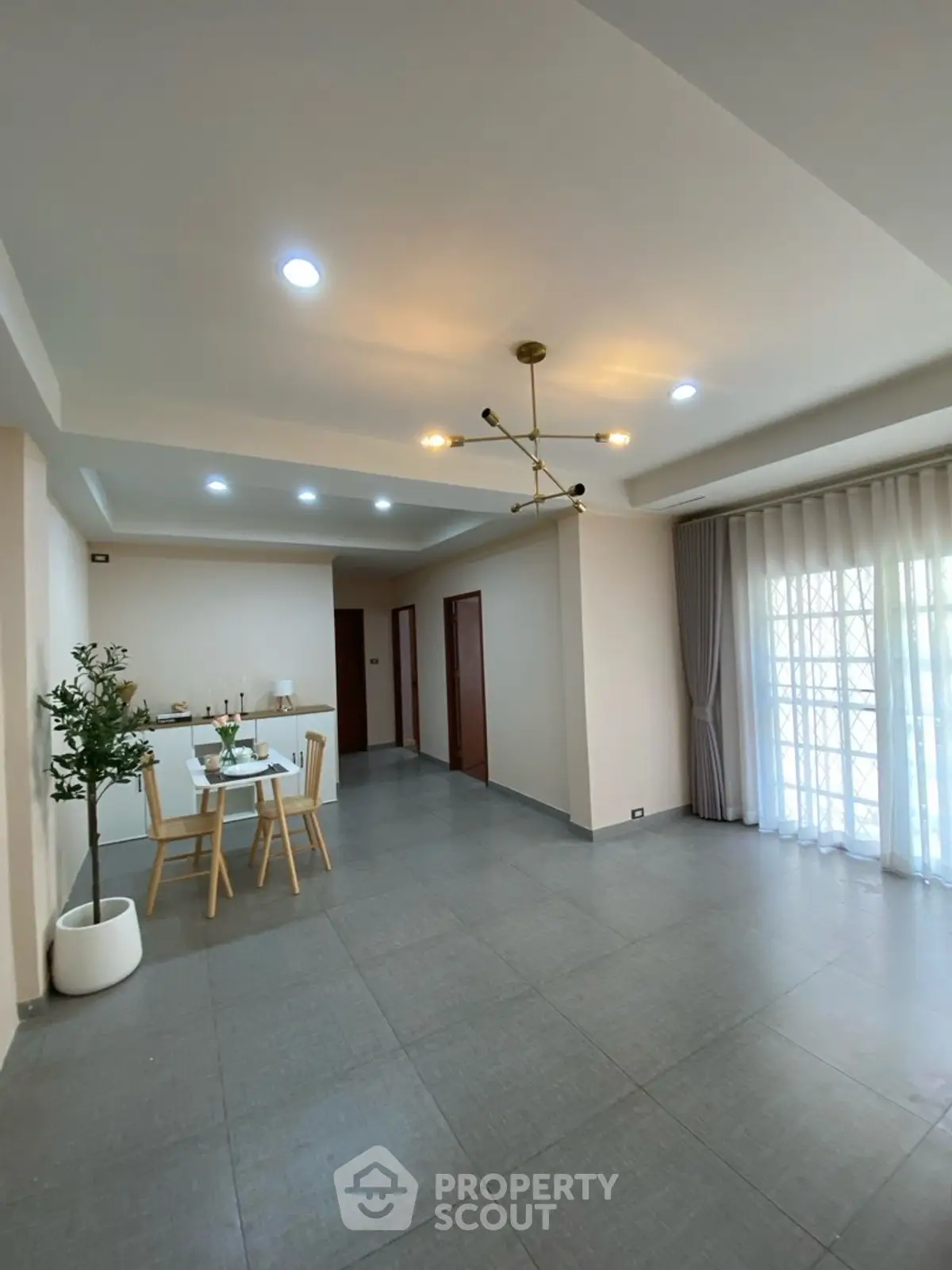 Spacious modern dining area with elegant lighting and large windows