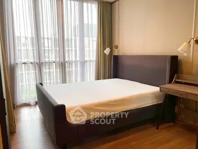 Modern bedroom with large windows and stylish furniture