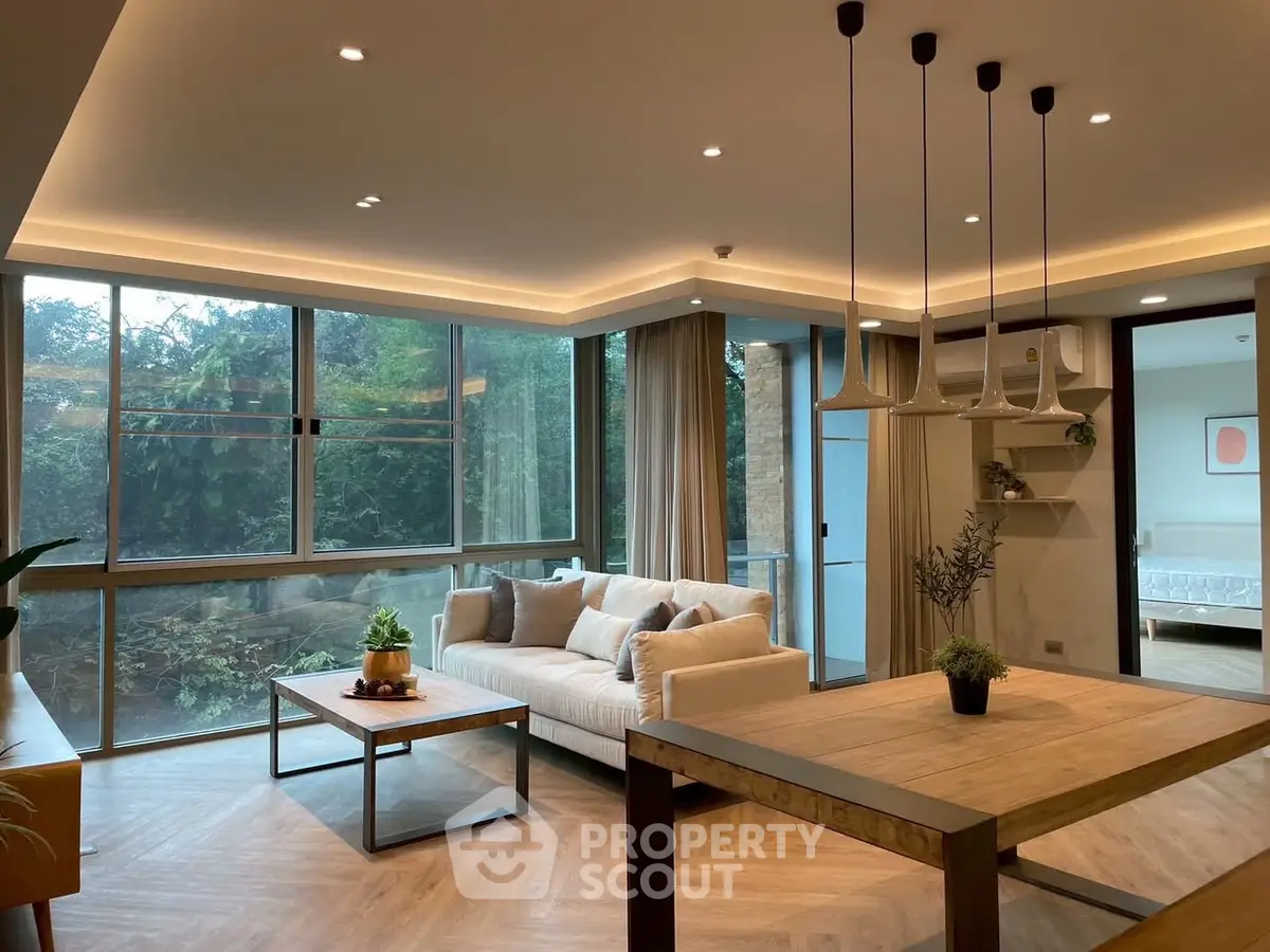 Luxurious modern living room with large windows and elegant lighting